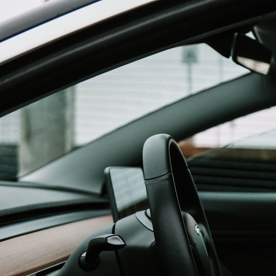 Professional mechanic servicing a Tesla car